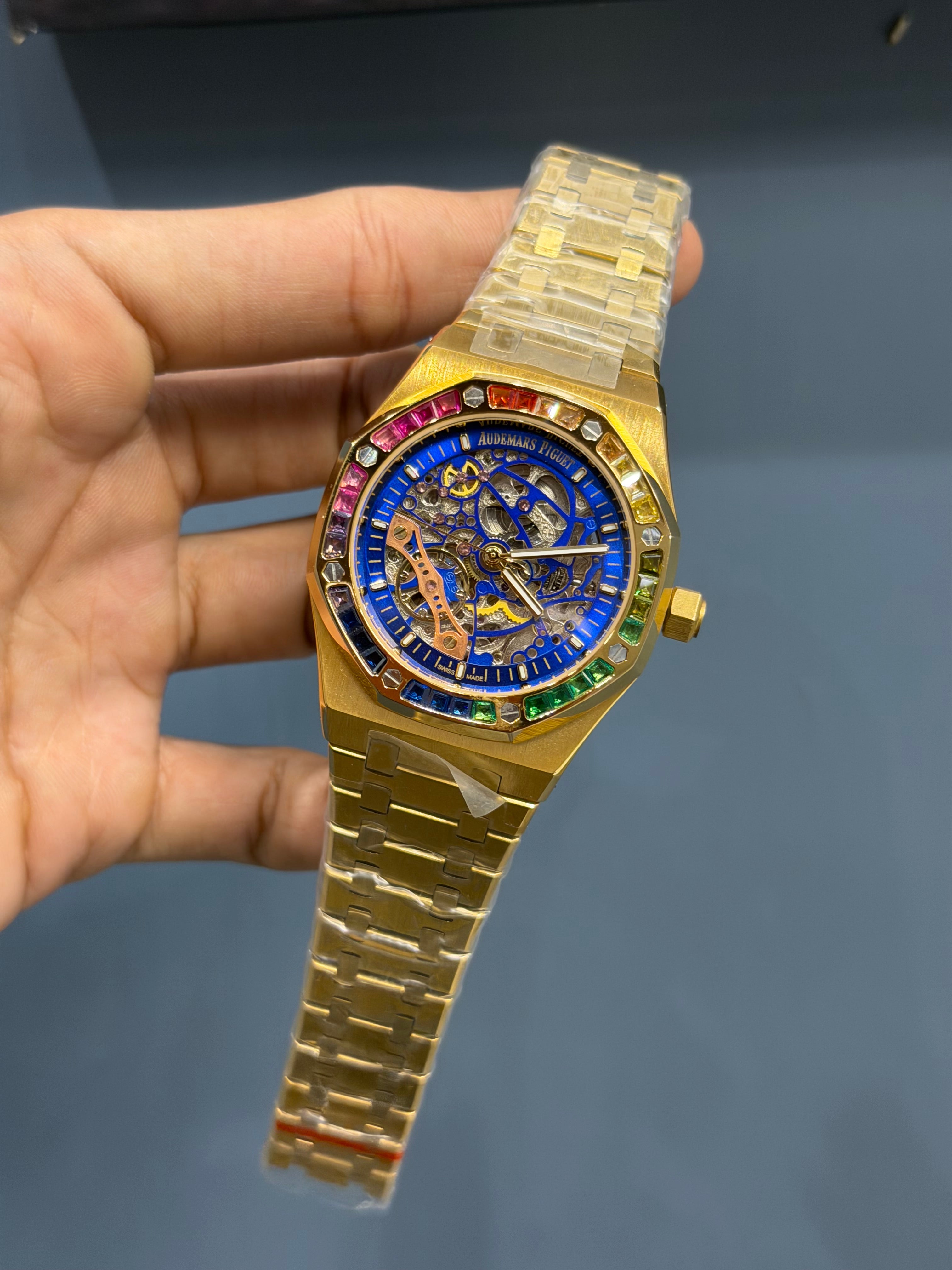 NEW COLLECTION YELLOW GOLD WITH BLUE SKELETON DIAL & RAINBOW STONE BEZEL