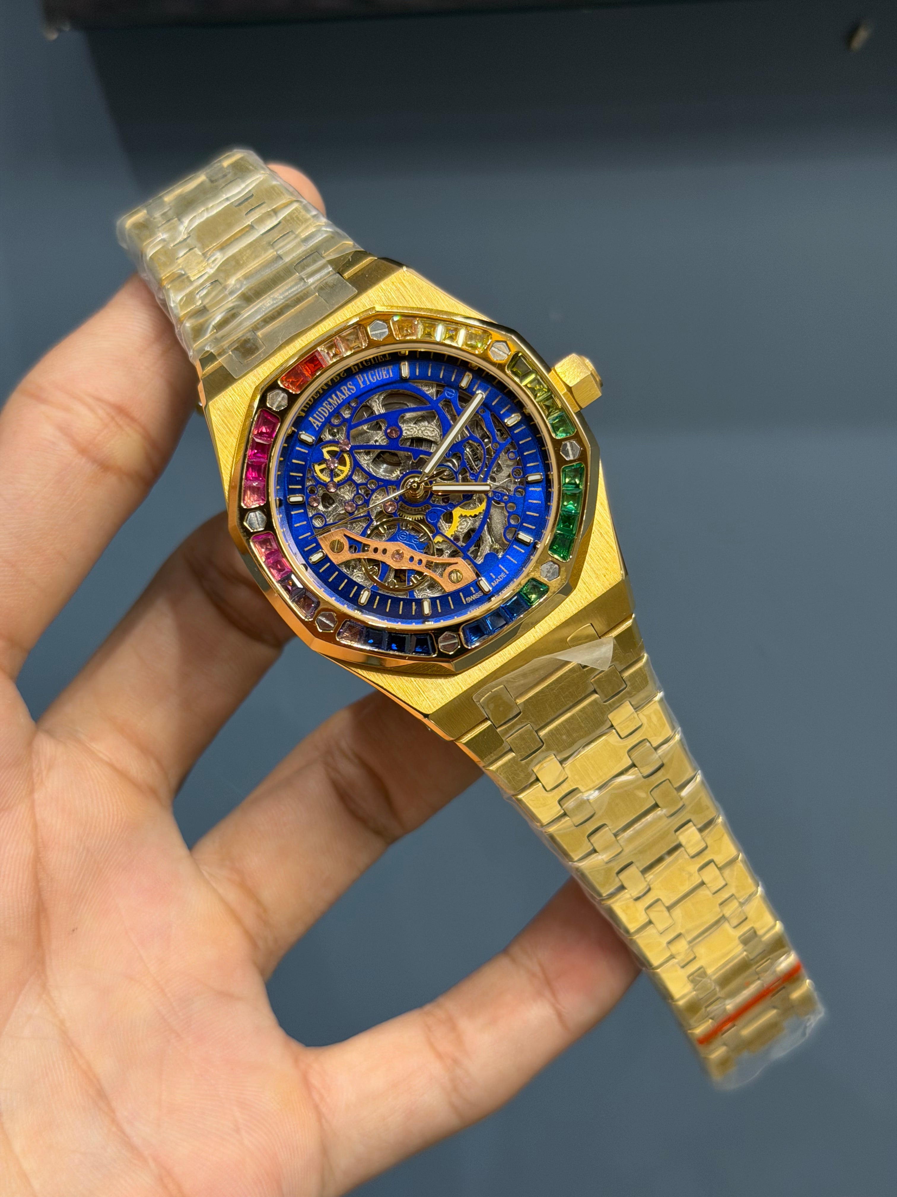 NEW COLLECTION YELLOW GOLD WITH BLUE SKELETON DIAL & RAINBOW STONE BEZEL